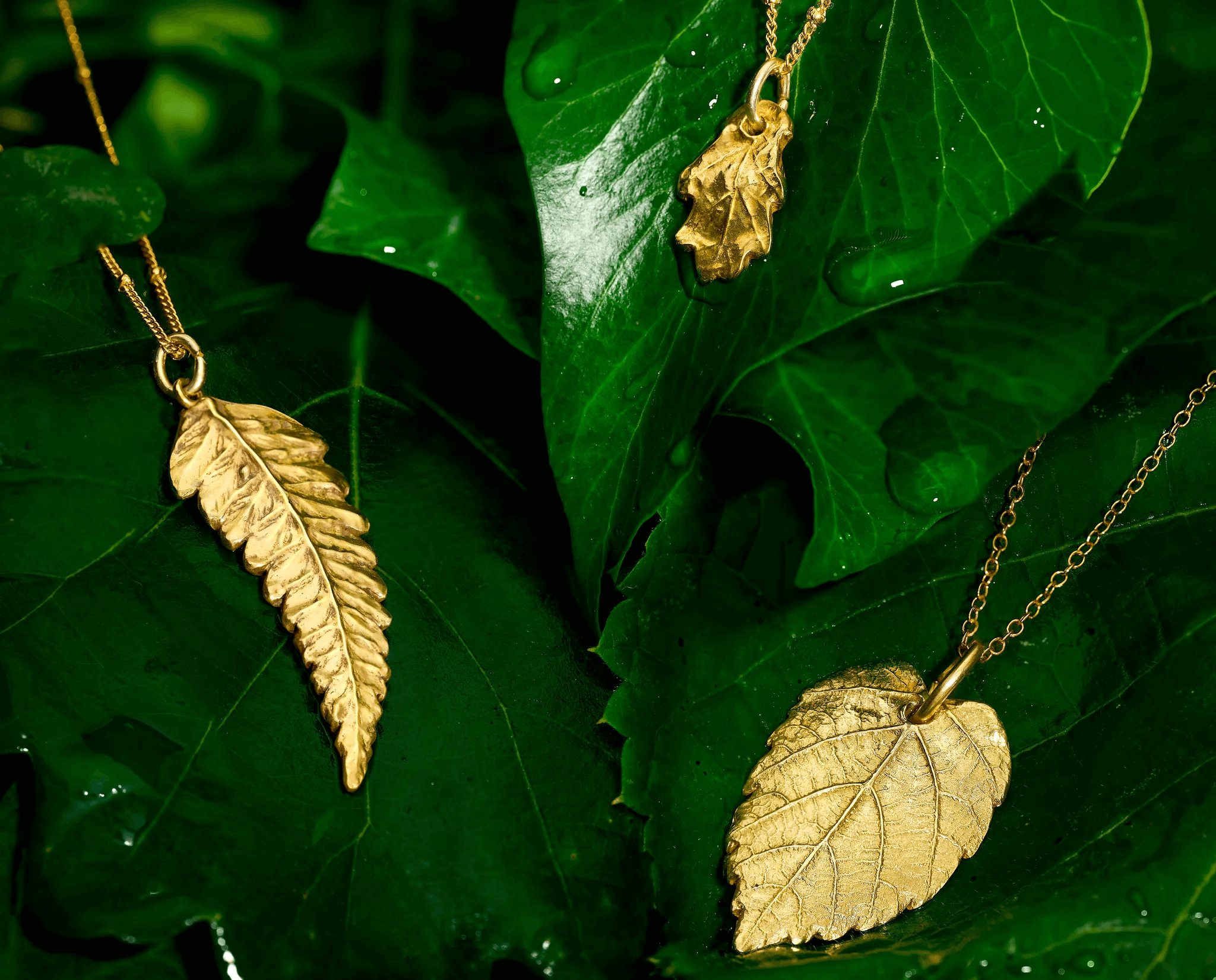 Iris and Lolli, real leaf pendant necklace, gold leaf necklaces laid together with foliage 