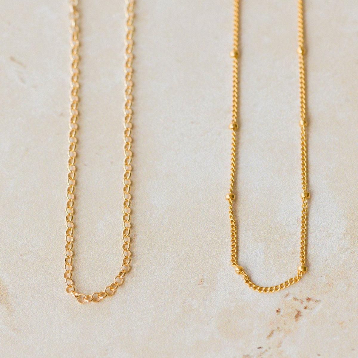 Model wearing Iris & Lolli solid 9ct gold coastal necklaces