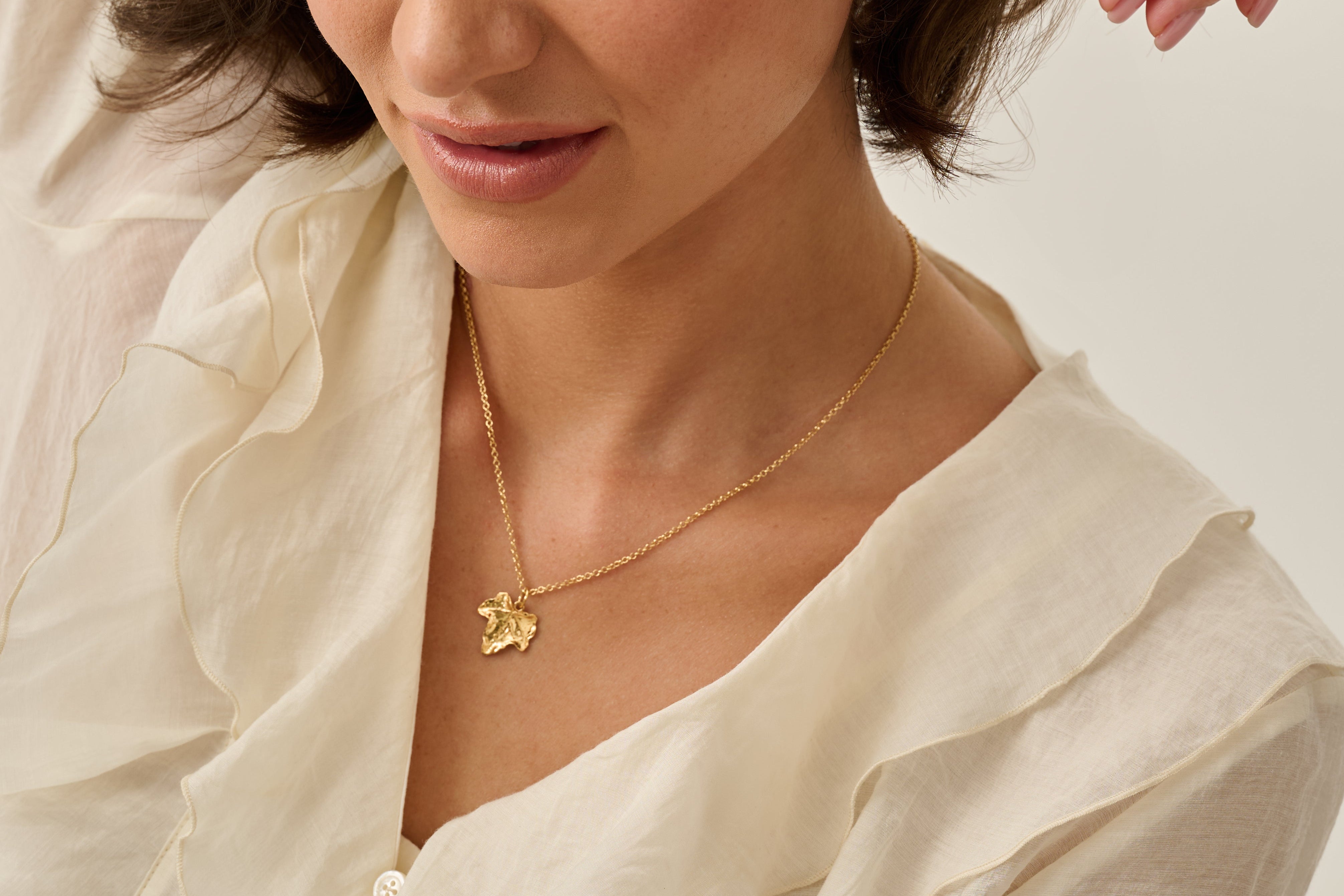 Iris and Lolli, real leaf pendant necklace, gold leaf necklaces laid together with foliage 