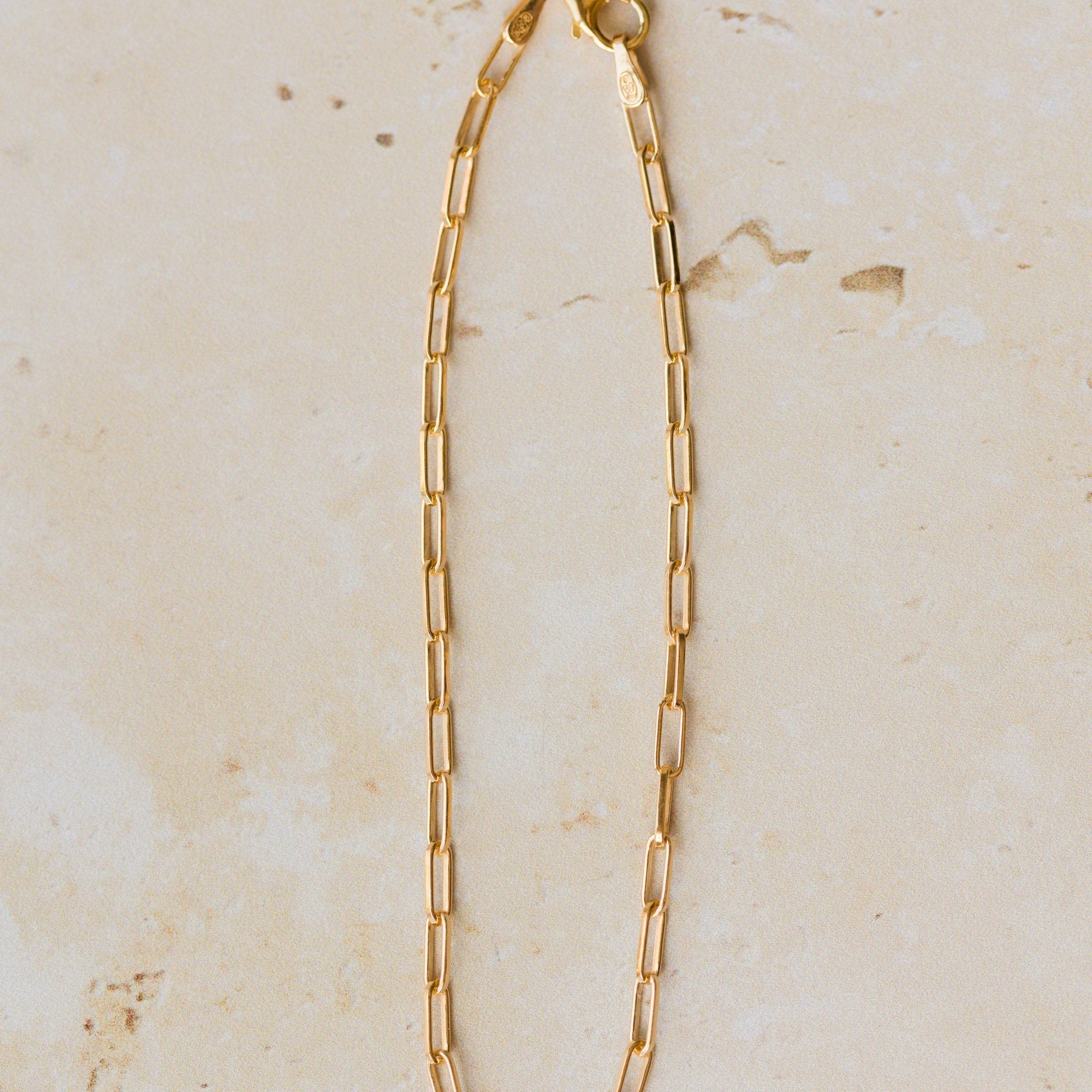 18ct gold vermeil fine paperclip chain bracelet displayed on neutral background by Iris & Lolli