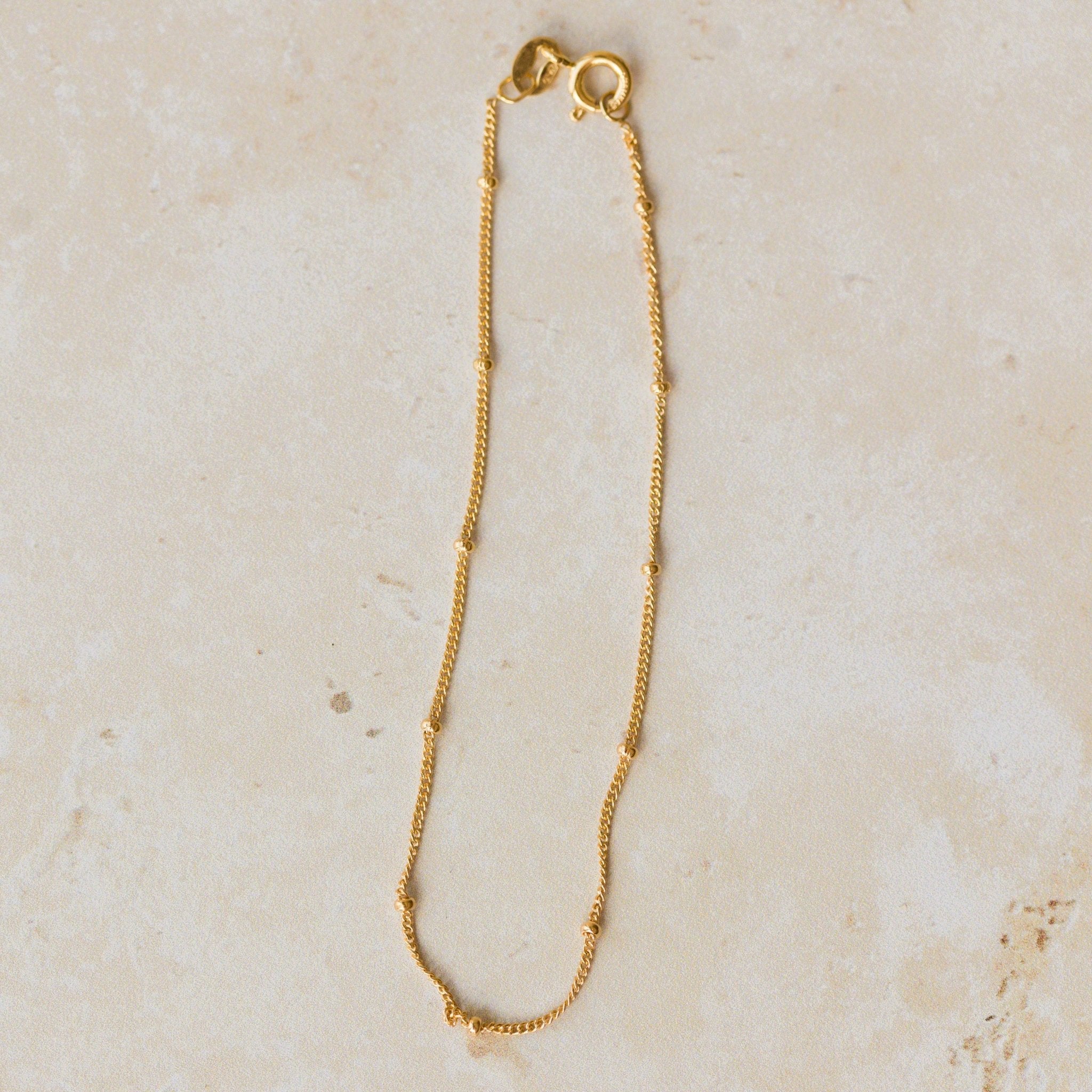 18ct gold vermeil satellite chain bracelet with delicate gold bead accents displayed on neutral background by Iris & Lolli