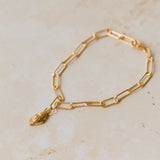18ct gold vermeil whelk shell charm bracelet with paperclip chain displayed on neutral background by Iris & Lolli