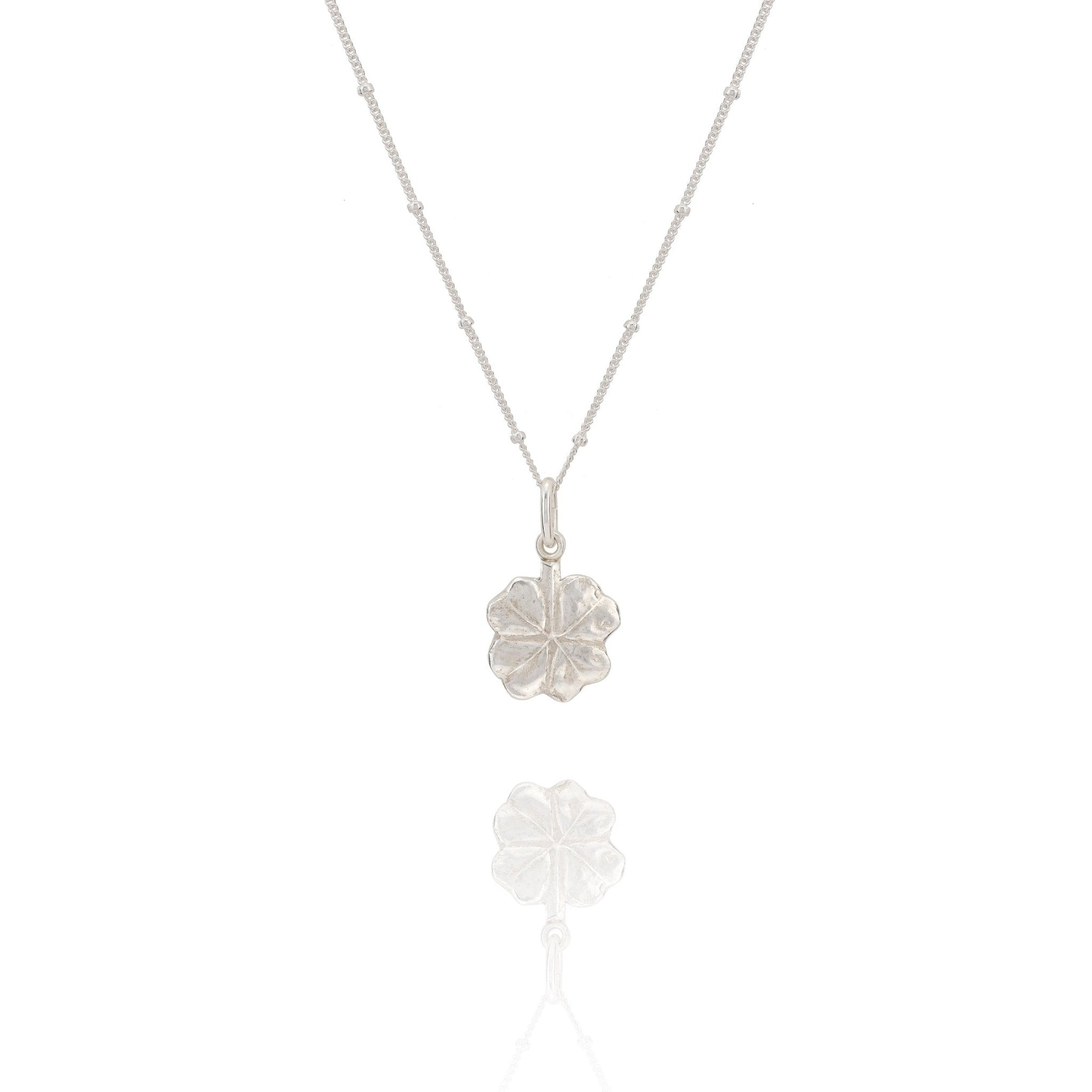 Silver necklace with a leaf pendant on a white background