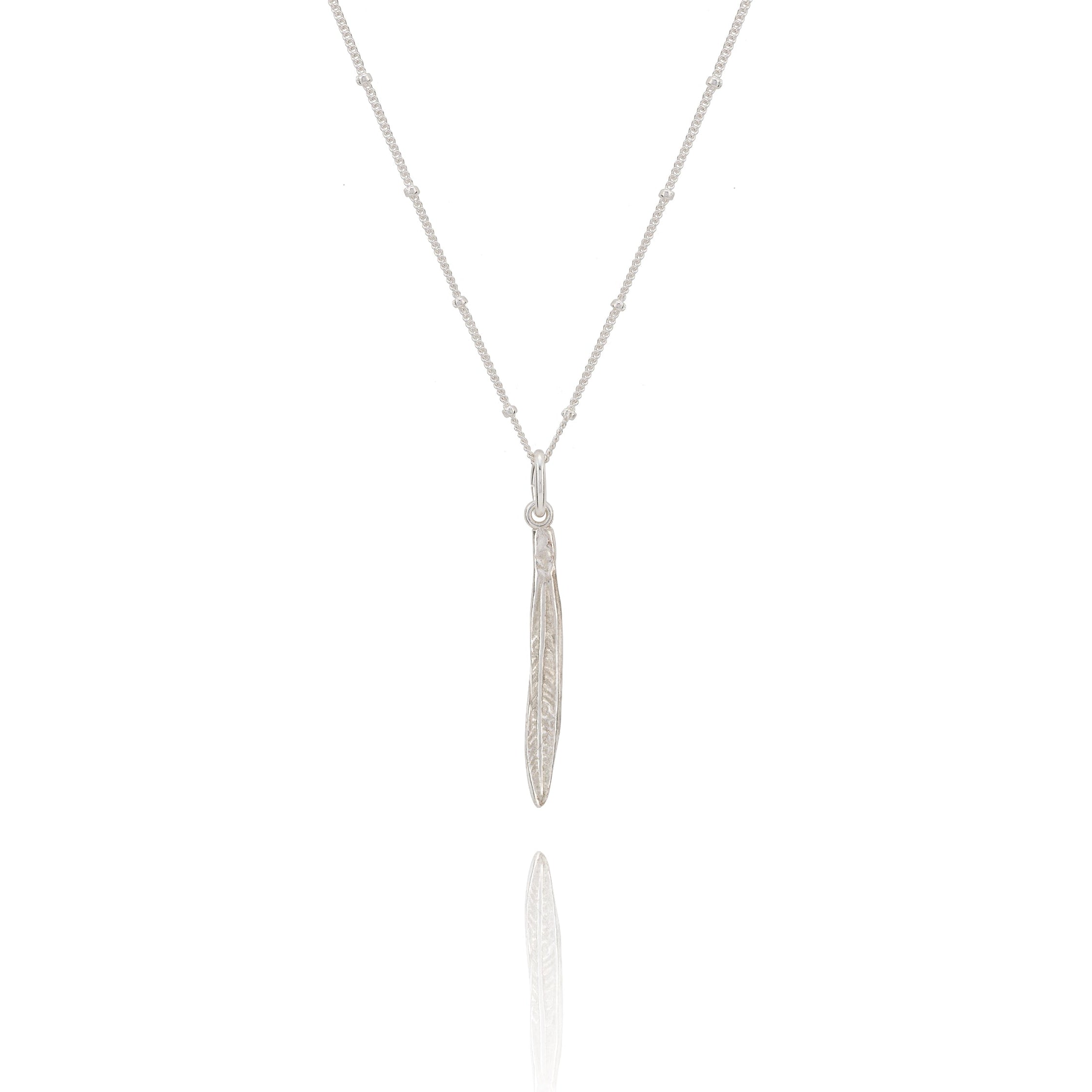 Silver necklace with a leaf pendant on a white background