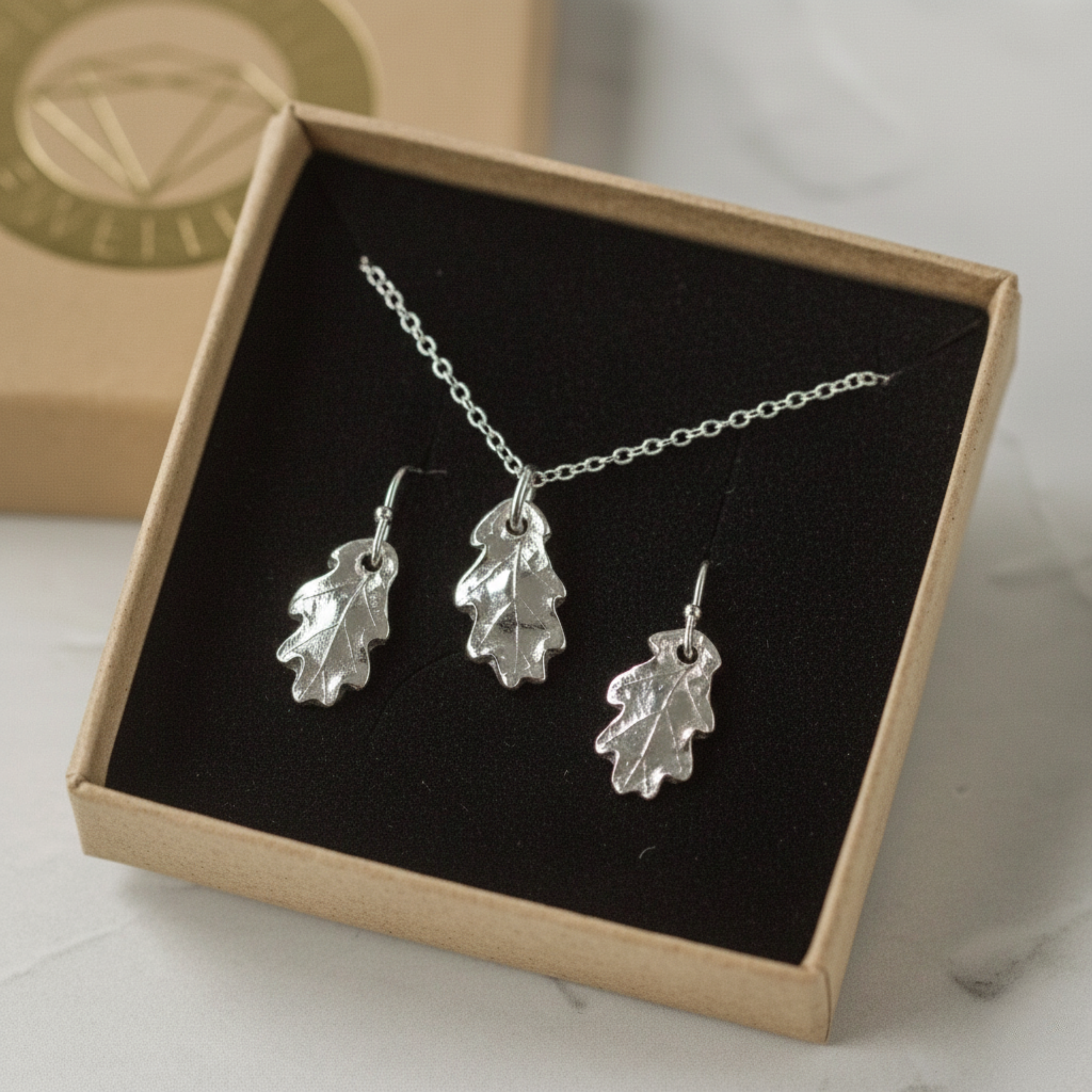 Silver oak leaf necklace and earring set presented as a botanical jewellery gift
