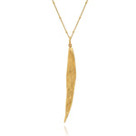 Gold necklace with a leaf pendant on a white background