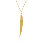 Gold necklace with a leaf pendant on a white background