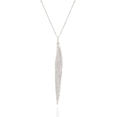 Silver necklace with a long, thin pendant on a white background