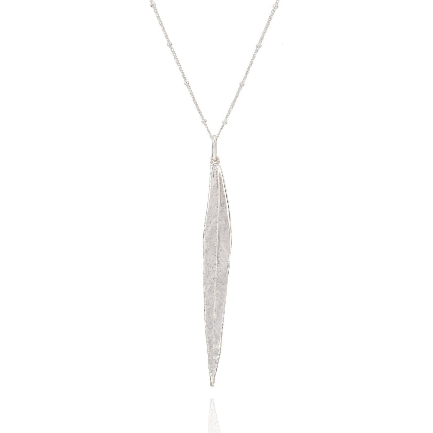 Silver necklace with a long, thin pendant on a white background