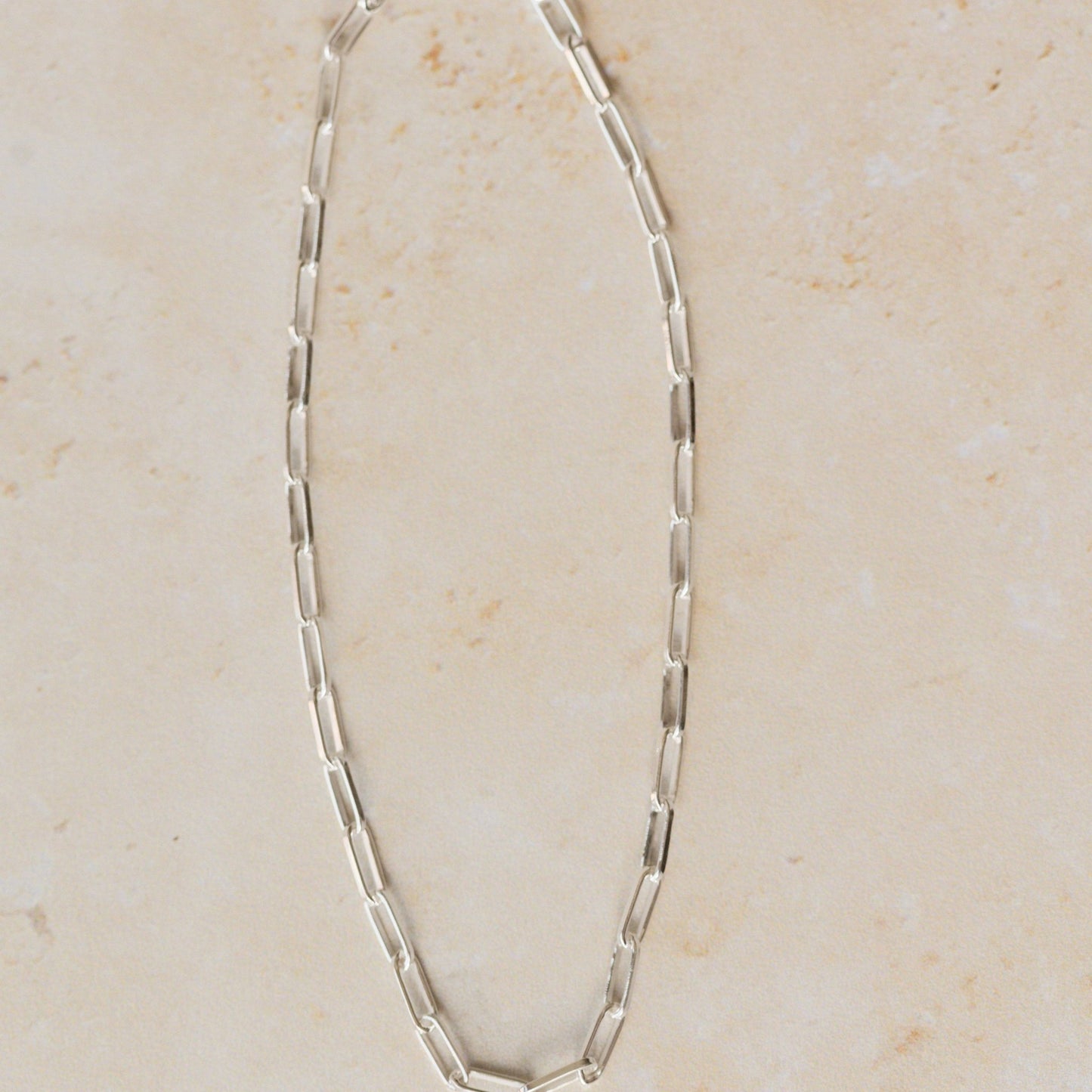 recycled silver fine paperclip chain bracelet displayed on neutral background by Iris & Lolli