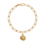 gold cockle shell charm bracelet with paperclip chain on white background, handcrafted coastal charm design by Iris & Lolli