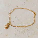 gold oak leaf charm bracelet with delicate paperclip chain styled on neutral stone surface, handcrafted woodland-inspired jewellery by Iris & Lolli