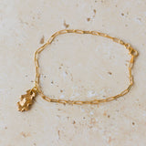 gold oak leaf charm bracelet with delicate paperclip chain styled on neutral stone surface, handcrafted woodland-inspired jewellery by Iris & Lolli