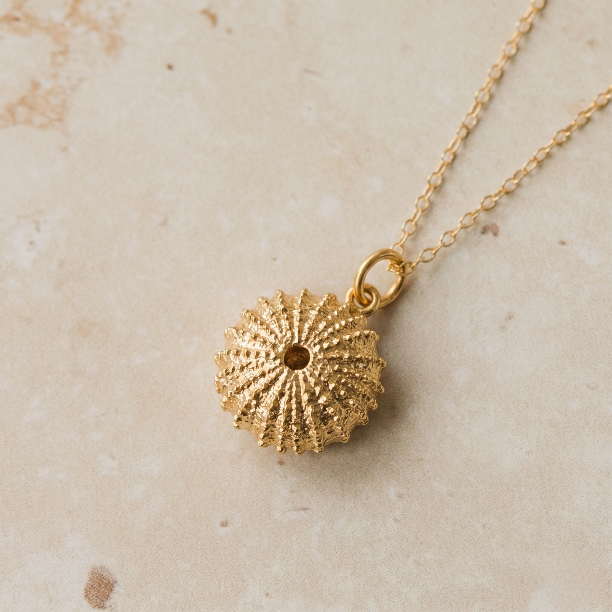 a gold sea urchin pendant necklace made bespoke within the uk 