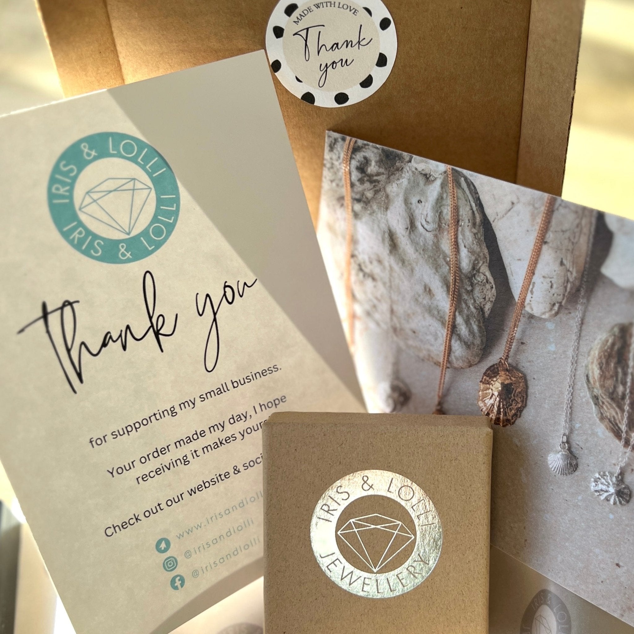 Iris & Lolli jewellery packaging with thank-you cards, gift boxes and brand inserts. Eco-friendly presentation perfect for artisan handmade jewellery orders.