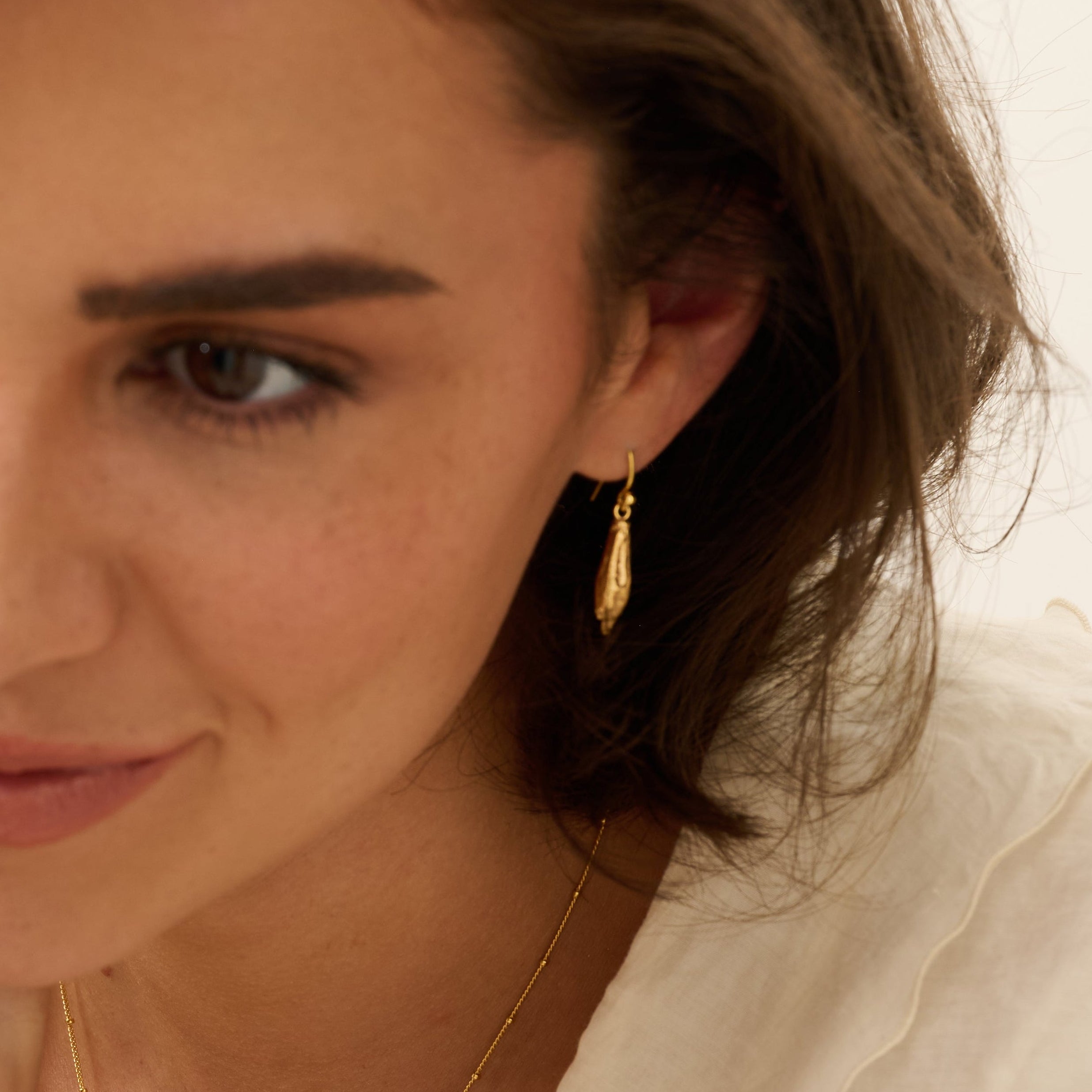 Model wearing Gold Welsh Poppy Earrings (1)