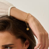 model wearing 18ct gold vermeil four-leaf clover bracelet on paperclip chain by Iris & Lolli