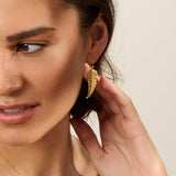 Model wearing handmade recycled gold fern leaf drop earring and necklace by Iris and Lolli, nature inspired and crafted in the UK