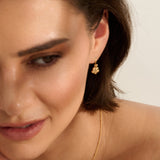Model wearing Iris & Lolli Gold Forget Me Not Drop Earrings handcrafted from recycled silver with an 18ct gold vermeil finish