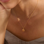 Model wearing Iris & Lolli Gold Four Leaf Clover Necklace with matching Gold Four Leaf Clover Drop Earrings handcrafted from recycled silver with an 18ct gold vermeil finish