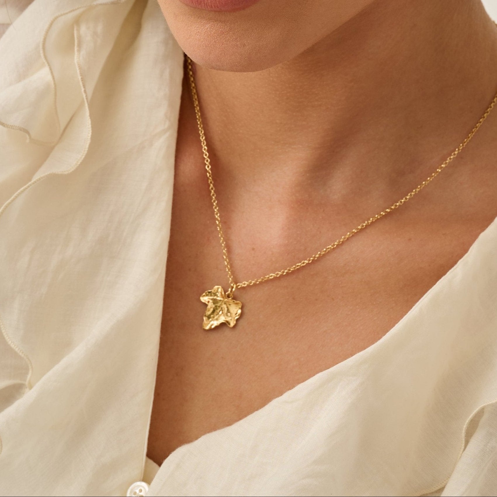 Model wearing Iris & Lolli Gold Ivy Leaf Necklace handcrafted from recycled silver with 18ct gold vermeil finish