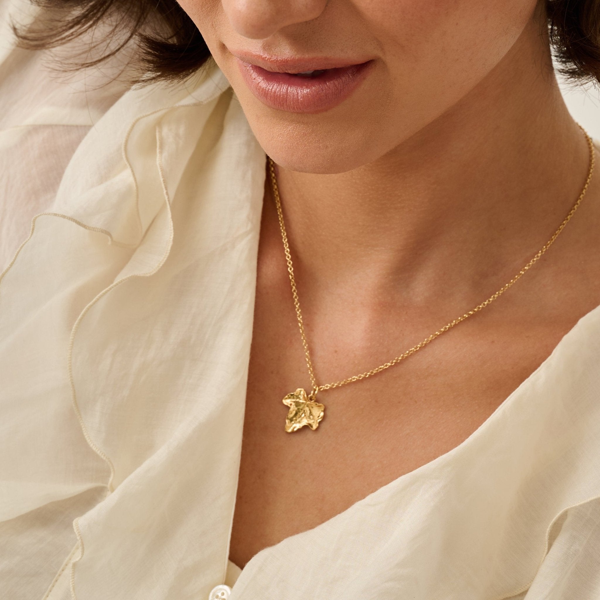 Model wearing Iris & Lolli Gold Ivy Leaf Necklace handcrafted from recycled silver with 18ct gold vermeil finish