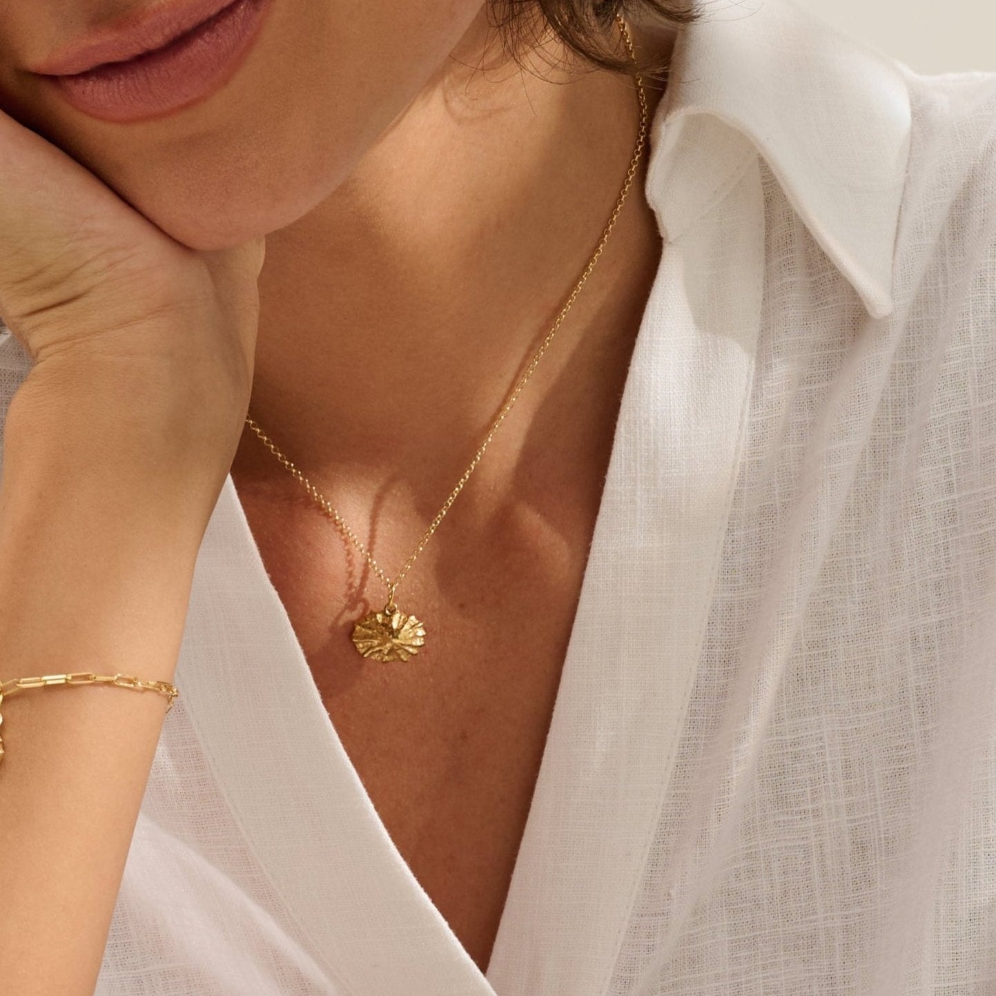 Model wearing Iris & Lolli Gold Limpet Necklace with matching Gold Limpet Earrings and Gold Whelk Shell Charm Bracelet handcrafted from recycled silver with 18ct gold vermeil finish