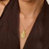 Model wearing Iris & Lolli Gold Oak Leaf Necklace with matching Gold Oak Leaf Earrings handcrafted from recycled silver with 18ct gold vermeil finish