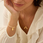 Model wearing Iris & Lolli Gold Sycamore Seed Necklace with Gold Earrings and Gold rose leaf Bracelet handcrafted from recycled silver with 18ct gold vermeil finish