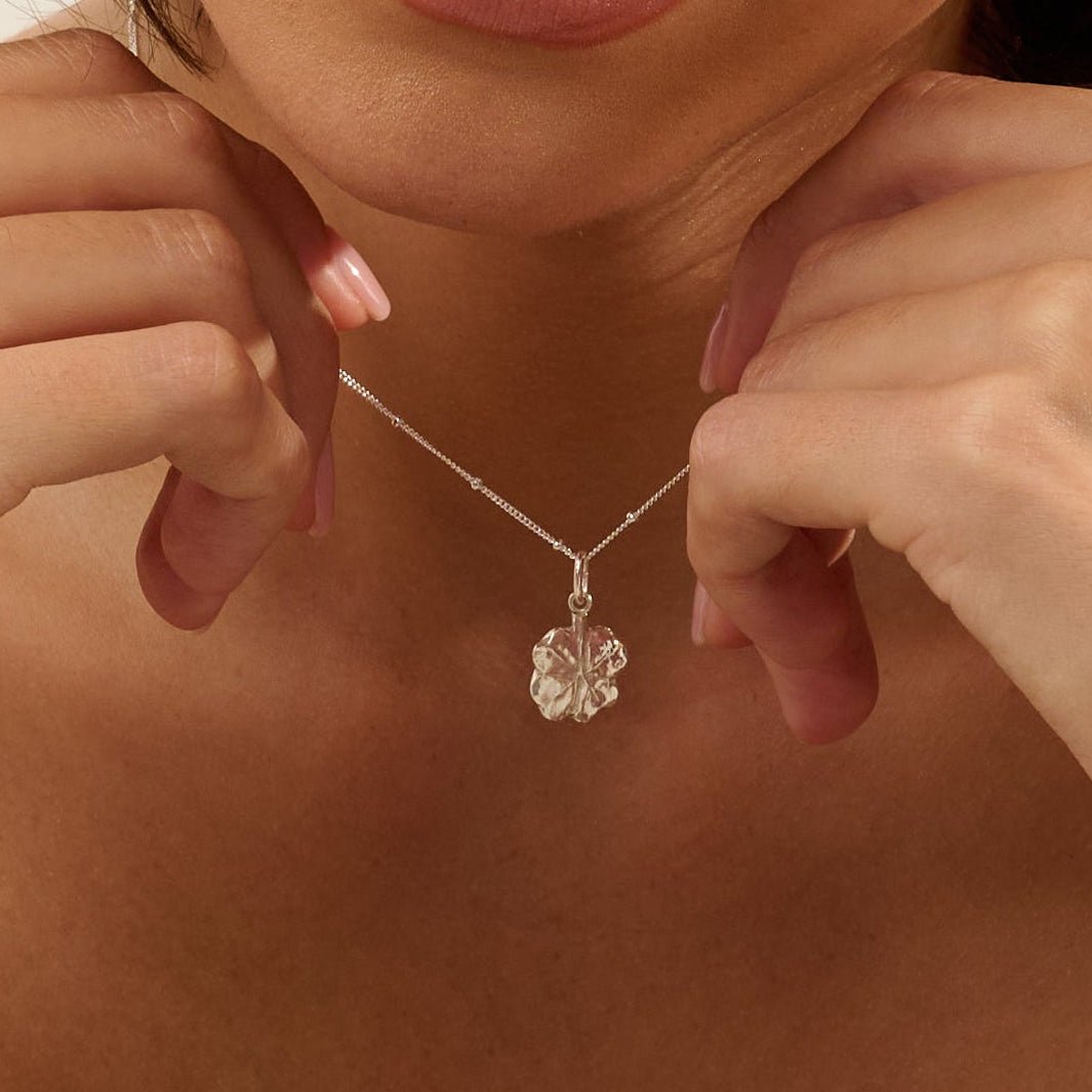 Model wearing Iris & Lolli Silver Four Leaf Clover Necklace with matching Silver Four Leaf Clover Drop Earrings handcrafted from recycled silver