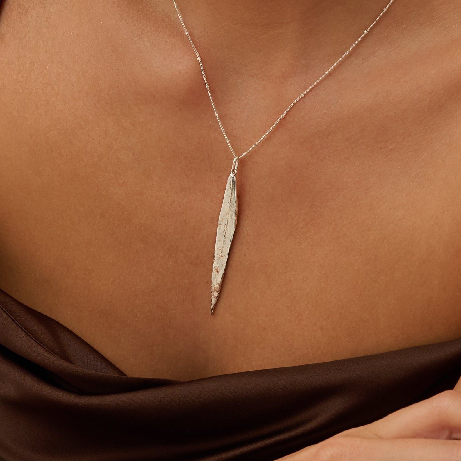 Model wearing Iris & Lolli Silver Willow Leaf Necklace with matching Silver Willow Leaf Drop Earrings handcrafted from recycled silver