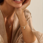 model wearing recycled silver whelk shell charm bracelet with matching silver necklace by Iris & Lolli