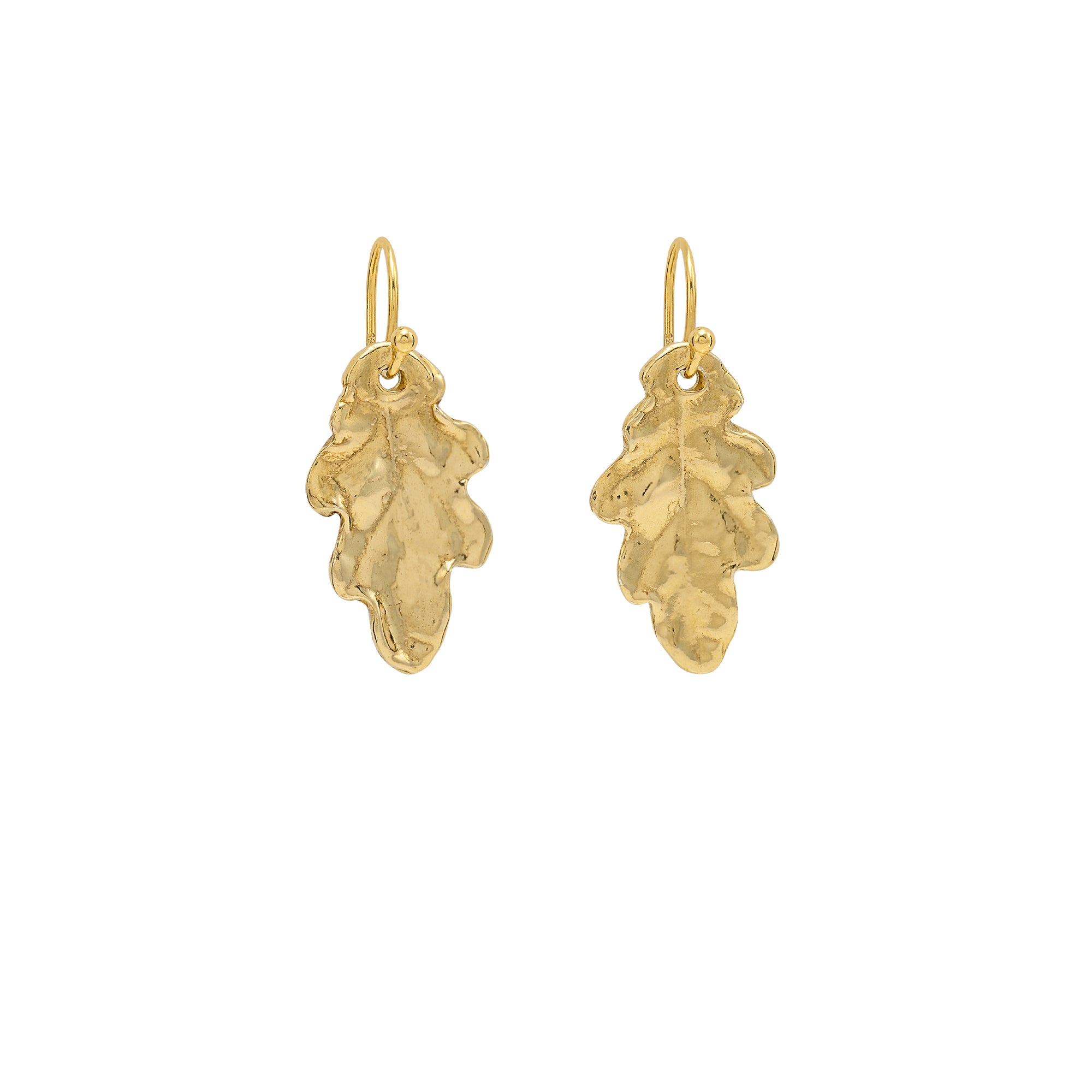 Handmade recycled gold small oak leaf drop earrings by Iris and Lolli on white background, nature inspired and crafted in the UK