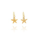 Handmade recycled gold starfish drop earrings by Iris and Lolli on white background, coastal inspired and crafted in the UK