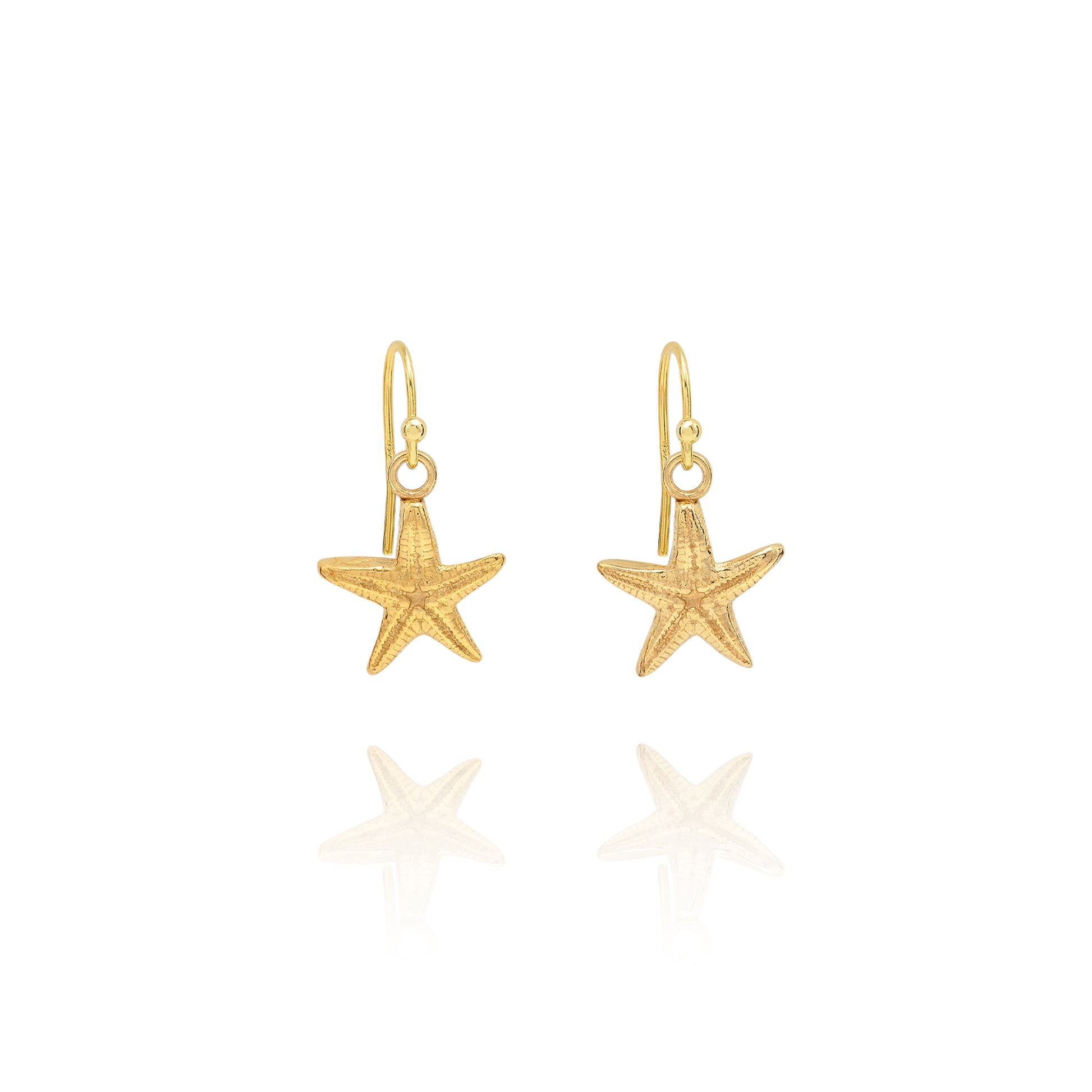 Handmade recycled gold starfish drop earrings by Iris and Lolli on white background, coastal inspired and crafted in the UK