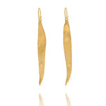 Handmade recycled gold long willow leaf drop earrings by Iris and Lolli on white background, nature inspired and crafted in the UK