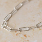close-up of recycled silver chunky paperclip chain bracelet links on neutral background by Iris & Lolli