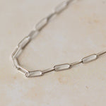 close-up of recycled silver fine paperclip chain bracelet links on neutral background by Iris & Lolli