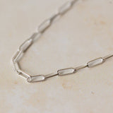 close-up of recycled silver fine paperclip chain bracelet links on neutral background by Iris & Lolli