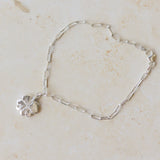 recycled silver four-leaf clover bracelet with paperclip chain displayed on neutral background by Iris & Lolli