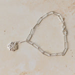 recycled silver four-leaf clover bracelet with paperclip chain on neutral background by Iris & Lolli