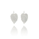 Handmade recycled silver hazel leaf drop earrings by Iris and Lolli on white background, nature inspired and crafted in the UK