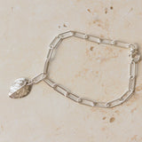handcrafted recycled silver rose leaf charm bracelet with paperclip chain on stone background, artisan eco silver jewellery by Iris & Lolli