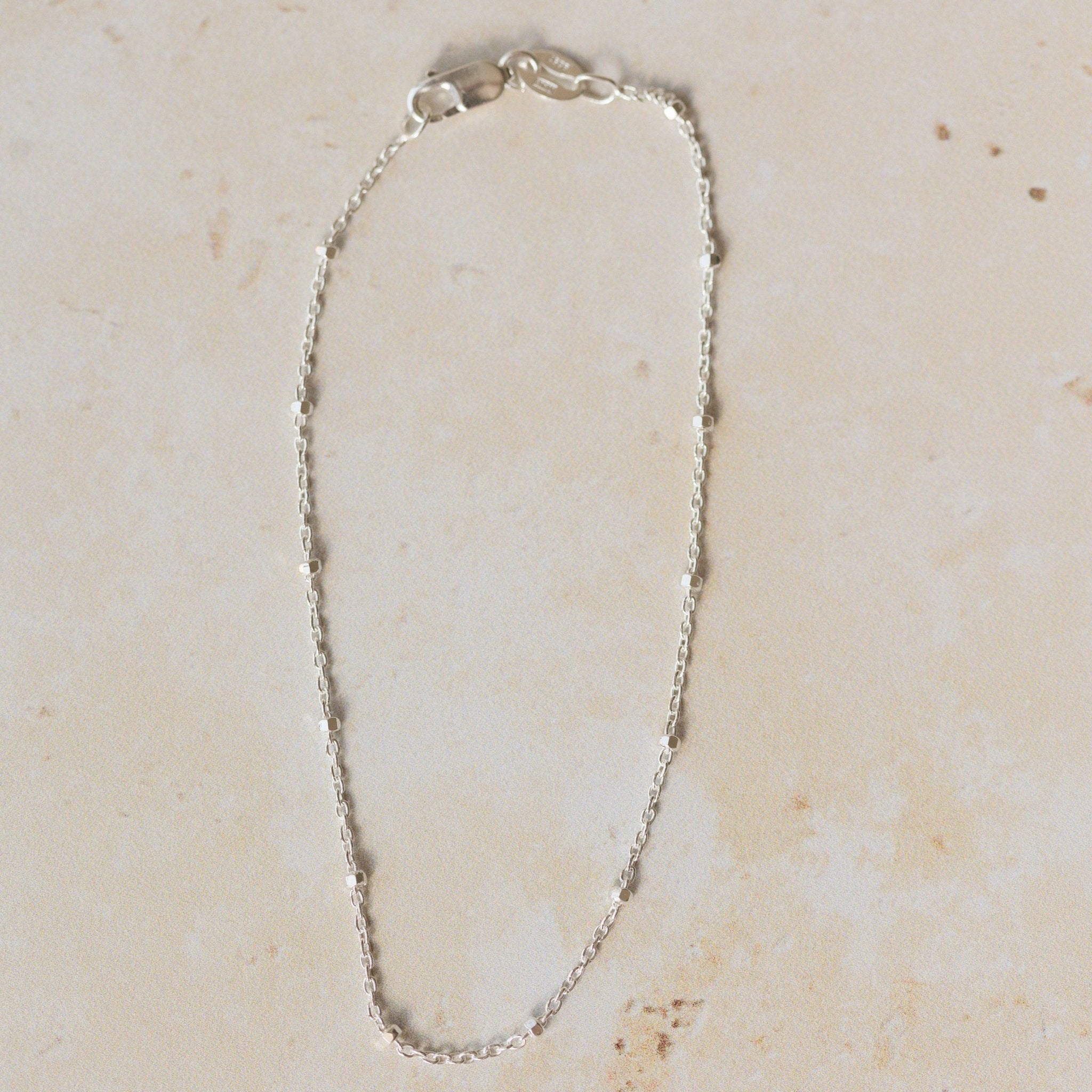 recycled silver satellite chain bracelet with delicate bead accents displayed on neutral background by Iris & Lolli