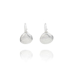 Handmade recycled silver Venus clam shell drop earrings by Iris and Lolli on white background, ocean inspired and crafted in the UK