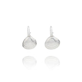 Handmade recycled silver Venus clam shell drop earrings by Iris and Lolli on white background, ocean inspired and crafted in the UK