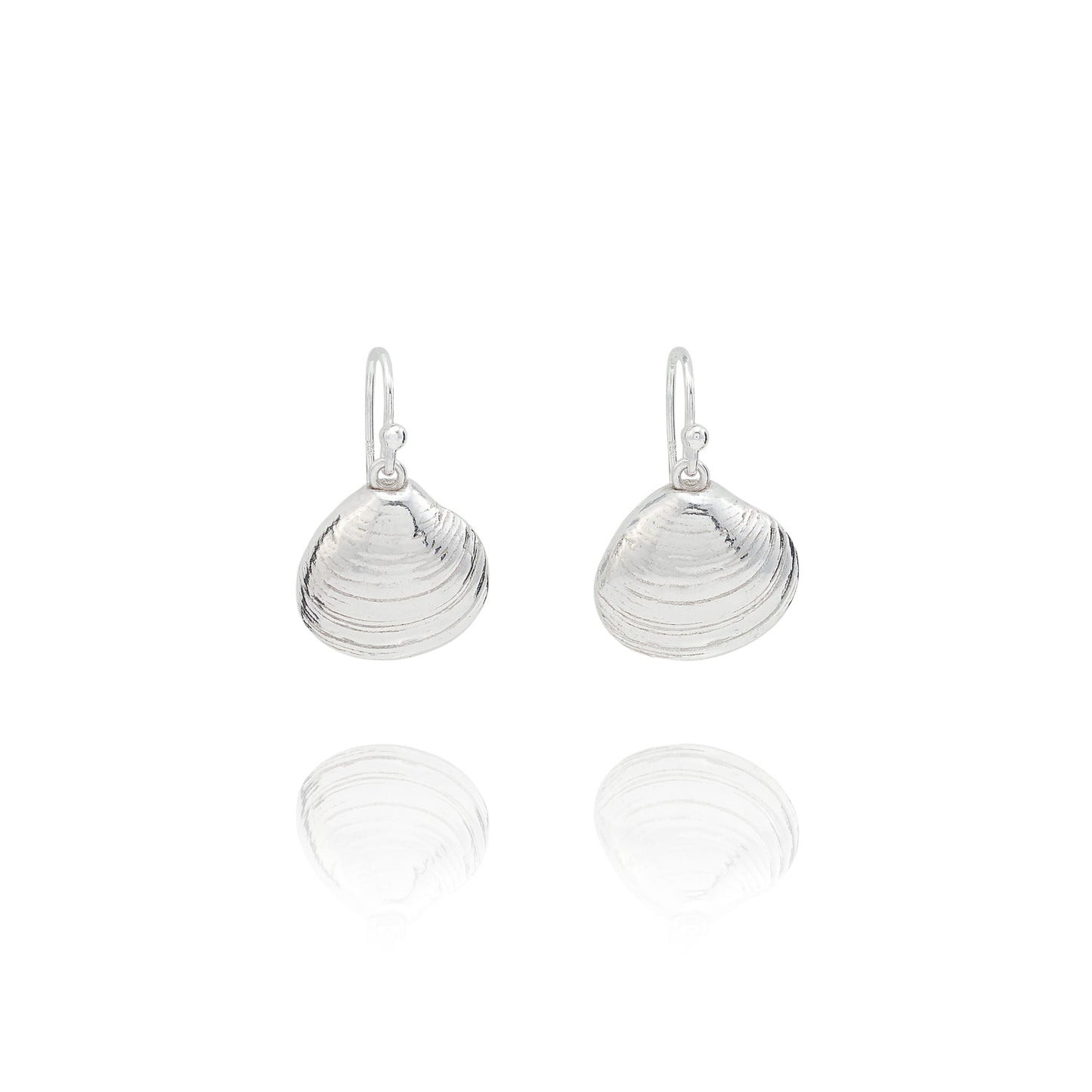 Handmade recycled silver Venus clam shell drop earrings by Iris and Lolli on white background, ocean inspired and crafted in the UK