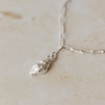close-up of recycled silver whelk shell charm bracelet on paperclip chain by Iris & Lolli
