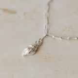 close-up of recycled silver whelk shell charm bracelet on paperclip chain by Iris & Lolli