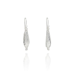 Handmade recycled silver Yellow Poppy Seed earrings by Iris and Lolli, nature inspired botanical drop earrings crafted in the UK on white background